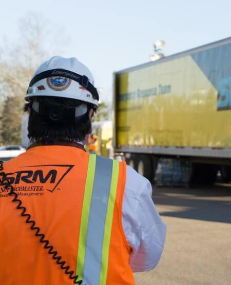 SRM technician in front of truck