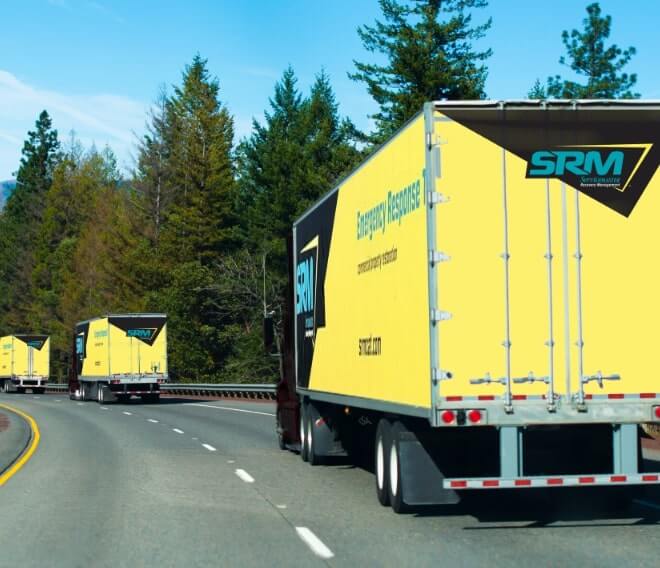 Fleet of ServiceMaster Recovery Management trucks on the way to a job site